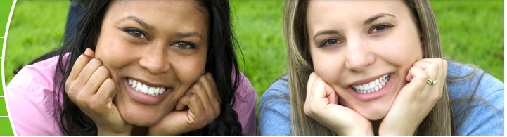 photo of two young women on grass